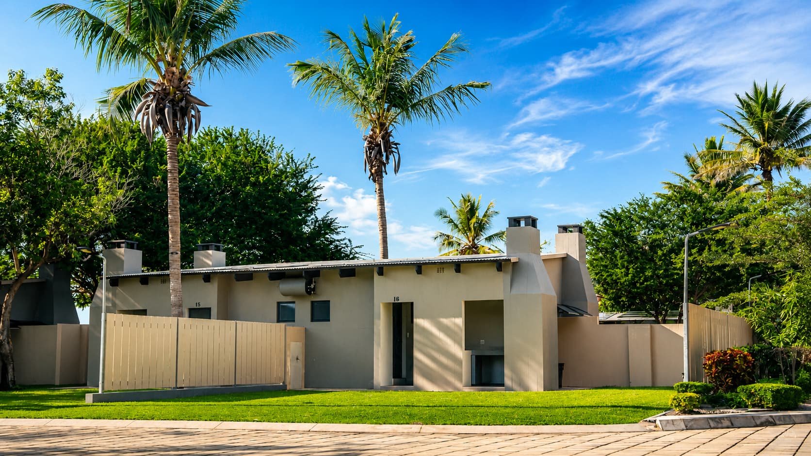 Premium stand exterior with private braai chimneys and palm trees