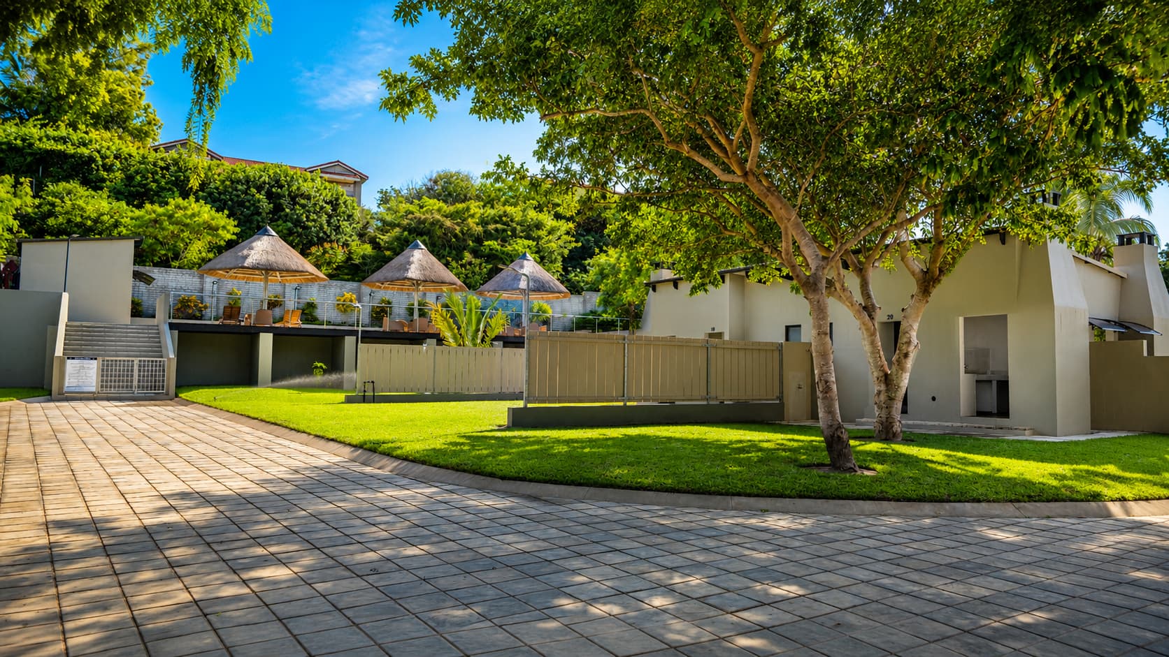 Elevated view of shaded Standard stands with thatched gazebo structures
