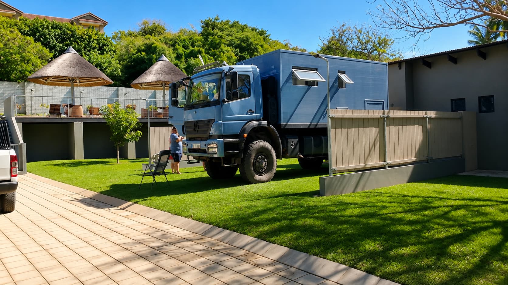 Overland camper parked in the shade of a large tree on a Standard stand