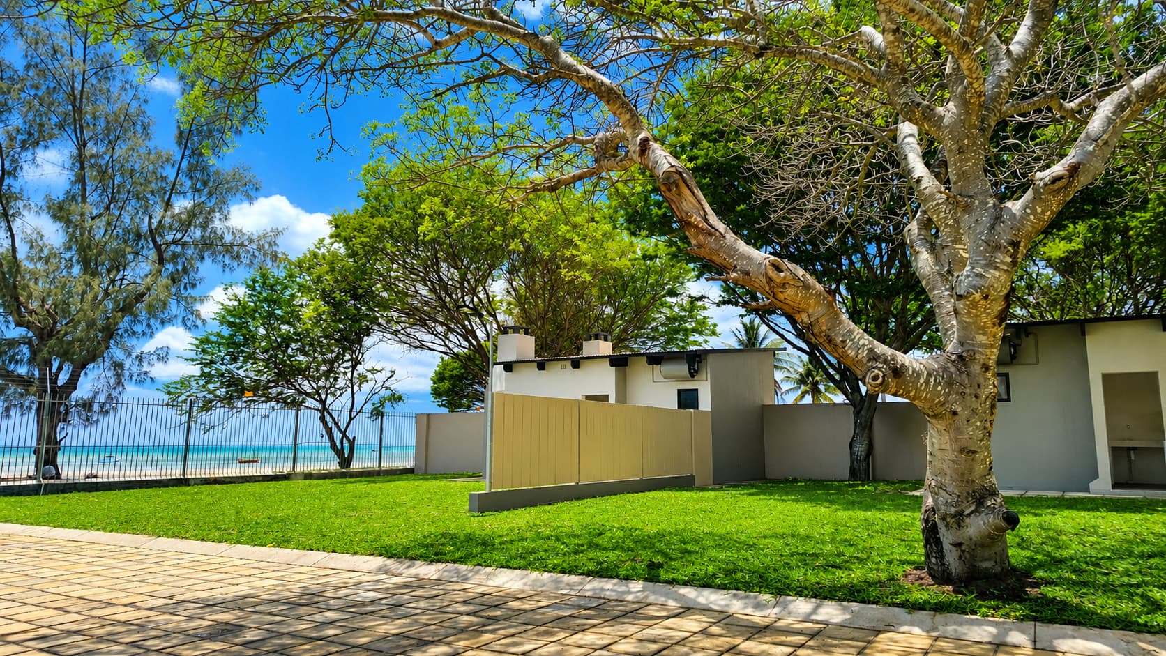 Private ablution block in a garden setting with the ocean in the distance